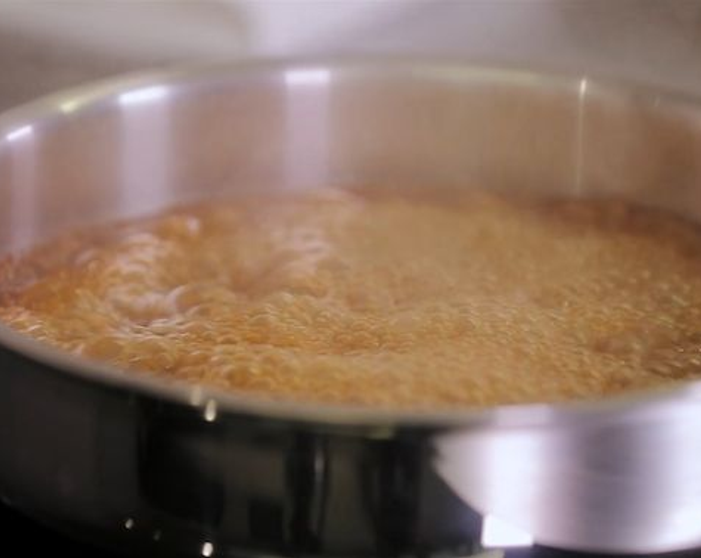 Schritt 6 Den Beutel danach aufschneiden und die Flüssigkeit in einer Pfanne sirupartig einkochen.