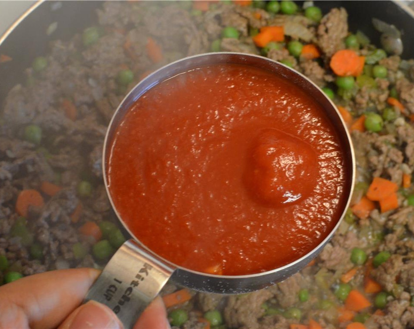 Schritt 7 Dann Tomatensauce (260 g) dazugeben, gut verrühren und zum Kochen bringen. Deckel aufsetzen, die Hitze reduzieren und die Sauce 10 Minuten köcheln lassen. Kurz vor Ende frisch gehackte Petersilie (1 Handvoll) unterrühren, dann Herd ausschalten.
