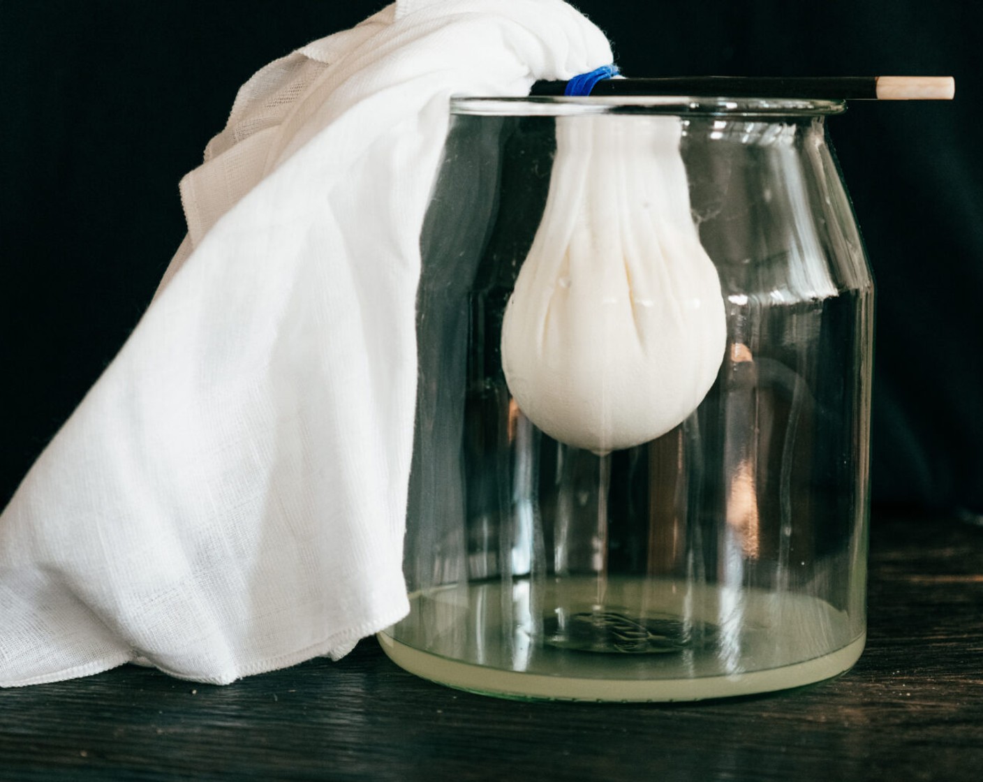 Schritt 3 Dann die Ecken zusammenbinden und das Bündel zum Abtropfen über die Schüssel hängen. Je nach Grösse der Schüssel, das Wasser immer wieder abgiessen. Das Bündel kann, muss aber nicht, im Kühlschrank abtropfen.